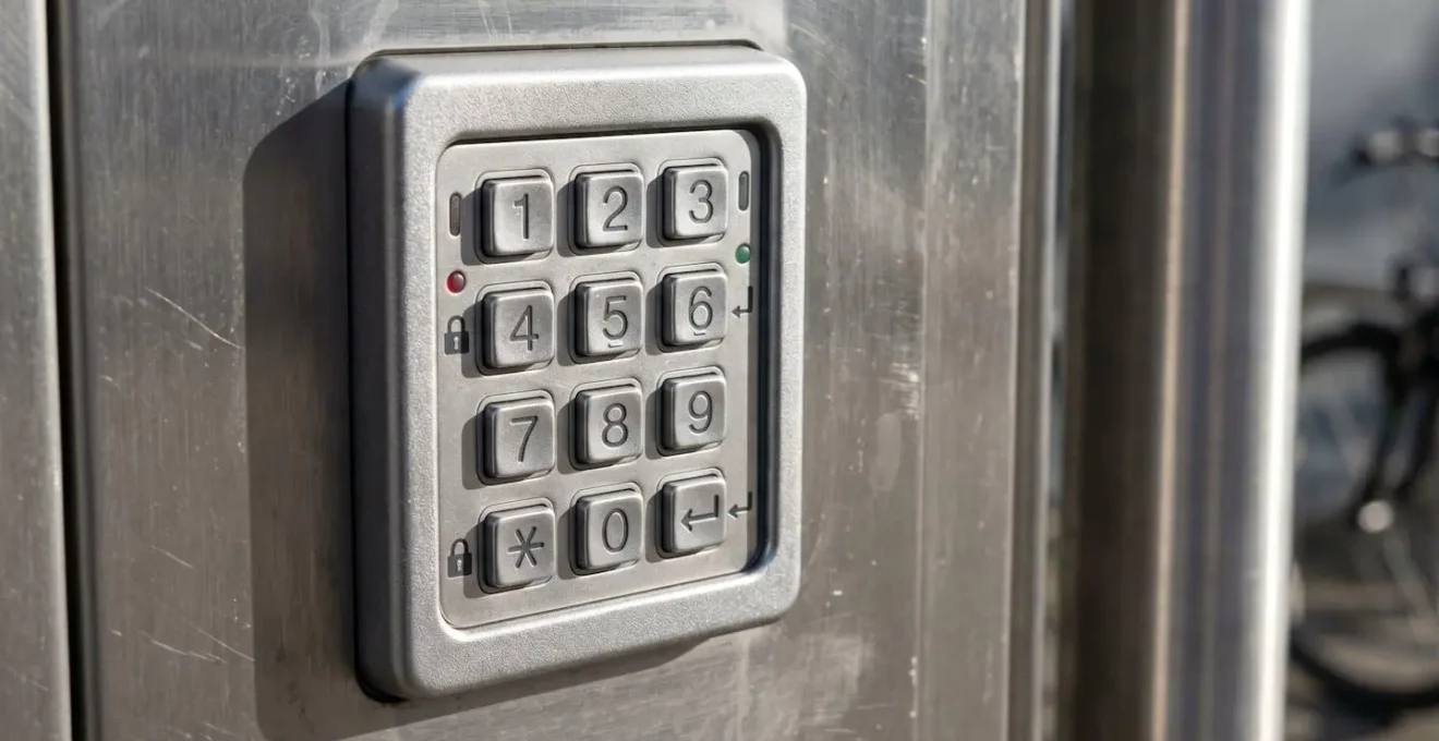 Gros plan sur un digicode moderne installé sur la porte d'un abri vélo sécurisé d'entreprise